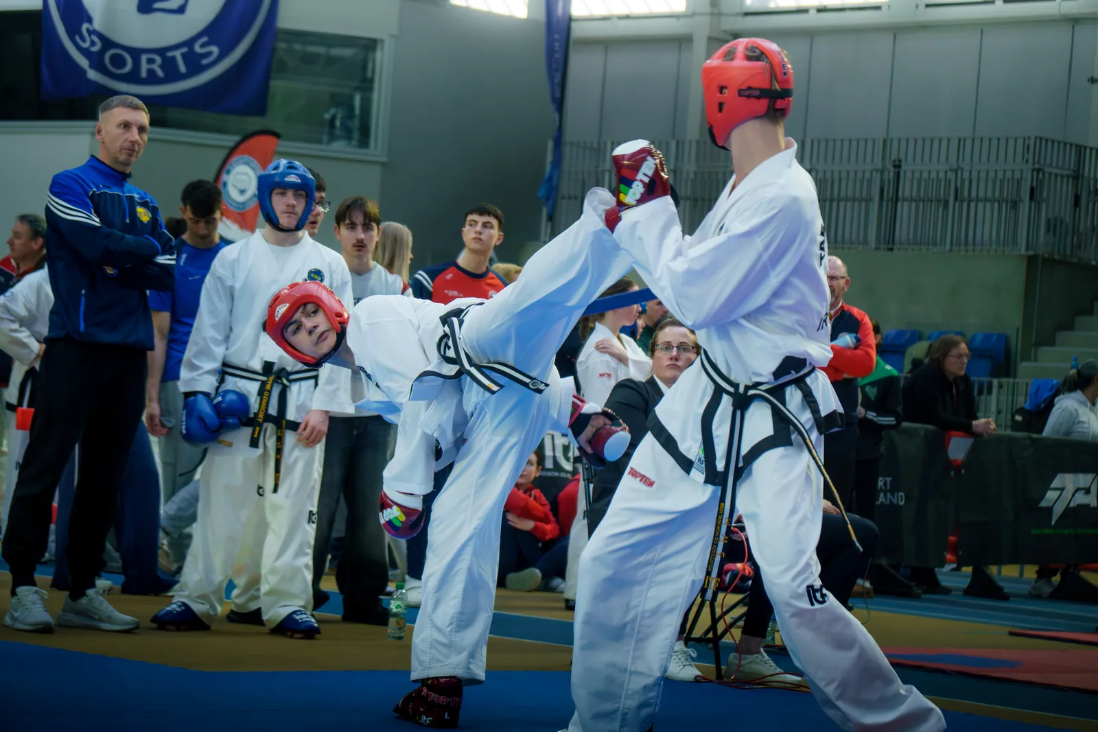 Competitors sparring in full protective equipment at a national event