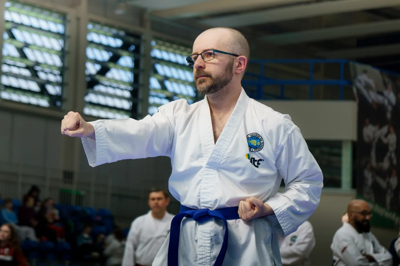 Adult coloured belt holding a guarding block stance